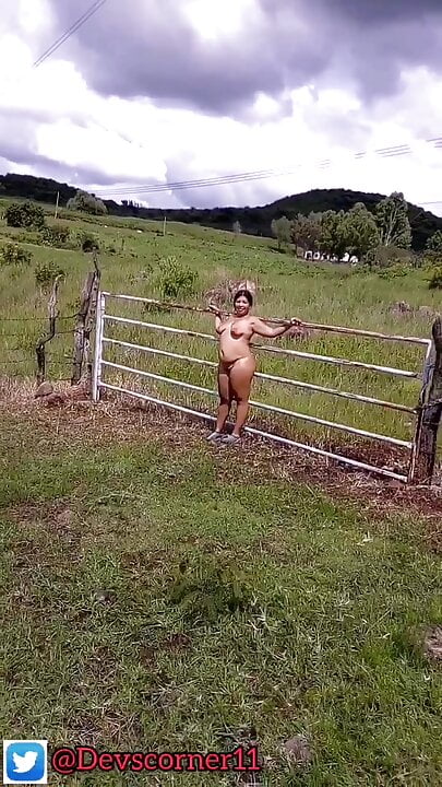 Devska walks completely naked by the country while cars go by