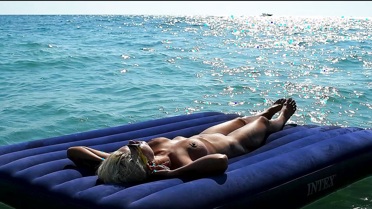 I watched on the beach how a naked girl with big tits was sunbathing on a mattress. Slow motion