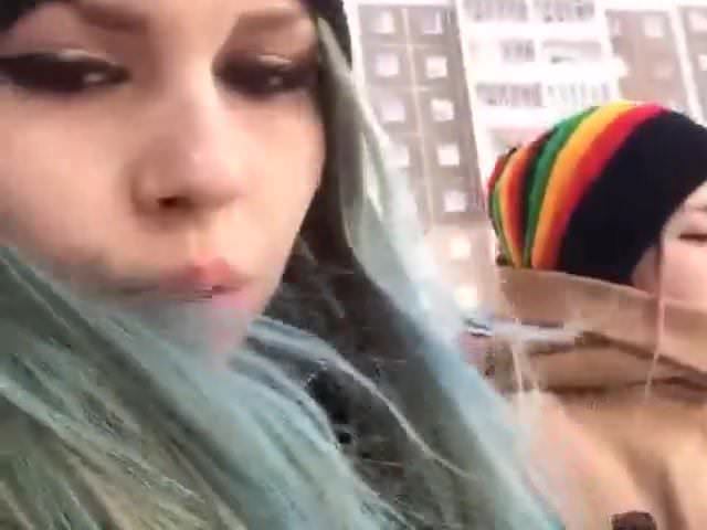 Two girls walk around the city and show their charms